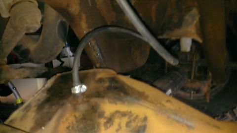 1994 Ford Bronco - Undercarriage view shows a fuel tank with hoses attached. The registry claims this is a 1994 Ford Bronco, but the image does not provide en…