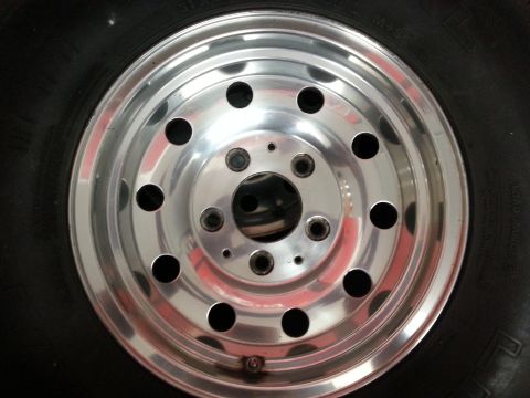 1994 Ford Bronco - A close-up view of a vehicle's aluminum alloy wheel and tire.