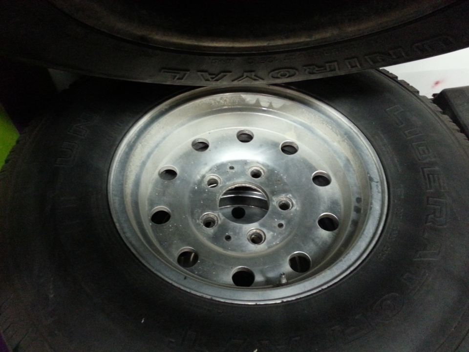 Aluminum alloy wheel with ten lug holes and a tire with visible text