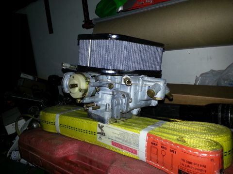 1994 Ford Bronco - Carburetor and air filter assembly sits on a yellow tow strap.