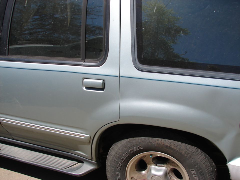 Silver SUV's rear door handle, trim, and wheel are visible. Tire has 'BFGOODRICH' text