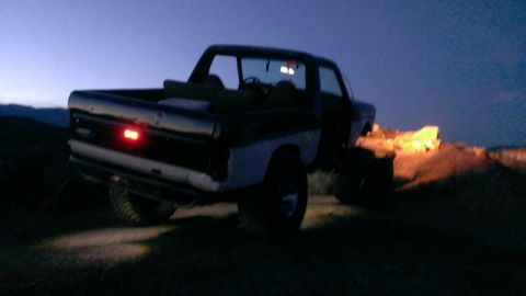 1994 Ford Bronco - This lifted Ford Bronco is parked on a dirt hill at twilight.