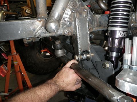 1961 International Scout 800 - Close-up of a custom steering linkage and a black shock absorber with 'ORI STRUTS' branding.