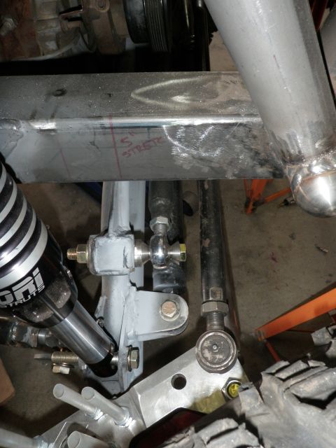 1961 International Scout 800 - Close-up view of custom vehicle steering and suspension parts, with markings on the frame indicating frame modification.