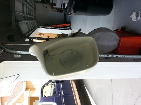 1994 Ford Bronco - A detached car side mirror is shown in a garage setting, with a portion of a dark blue vehicle visible.