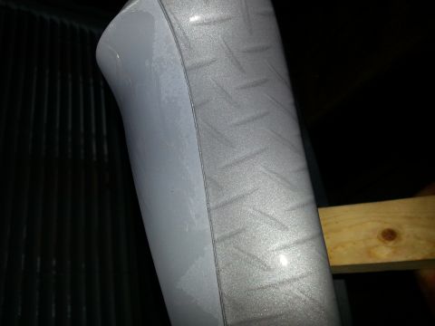 1994 Ford Bronco - Close-up of a diamond plate pattern on a curved surface, likely a vehicle part.