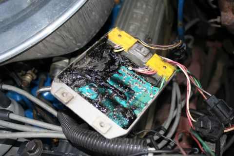 1980 Ford Mustang - Close-up of a damaged ignition module, showing melted components and exposed wiring.