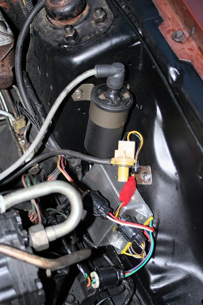 1980 Ford Mustang - Close-up view of the ignition coil and wiring harness in a 1980 Ford Mustang engine bay.