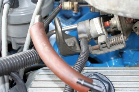 1980 Ford Mustang - Close-up view of engine parts, including a hose and electrical connectors, with visible part number E0ZE 3203.