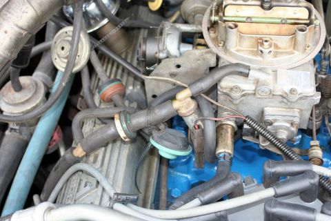 1980 Ford Mustang - Close-up view of an engine bay, showing various components like the carburetor and distributor.