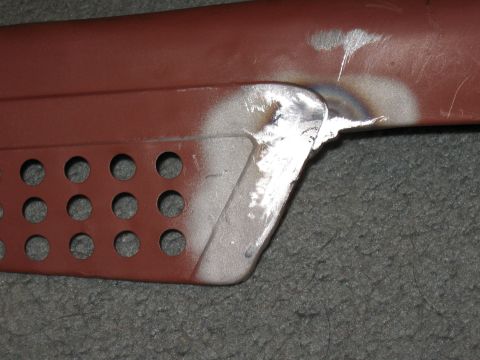 1994 Ford Bronco - A close-up view of a metal component, likely a step or running board, a pattern of circular perforations and evidence of recent welding and…