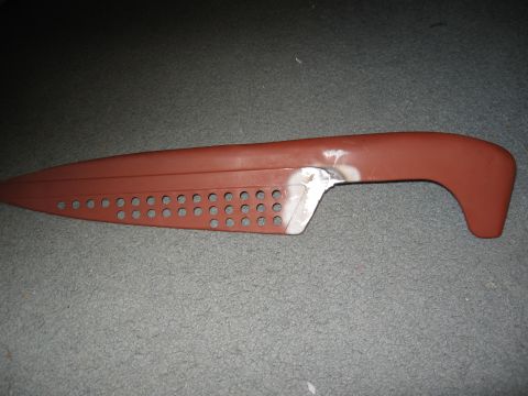 1994 Ford Bronco - A car door handle with a metal repair patch is shown against a carpeted surface.