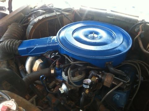 1977 Ford F-350 - Close-up of an engine bay, focusing on the air cleaner and surrounding parts.