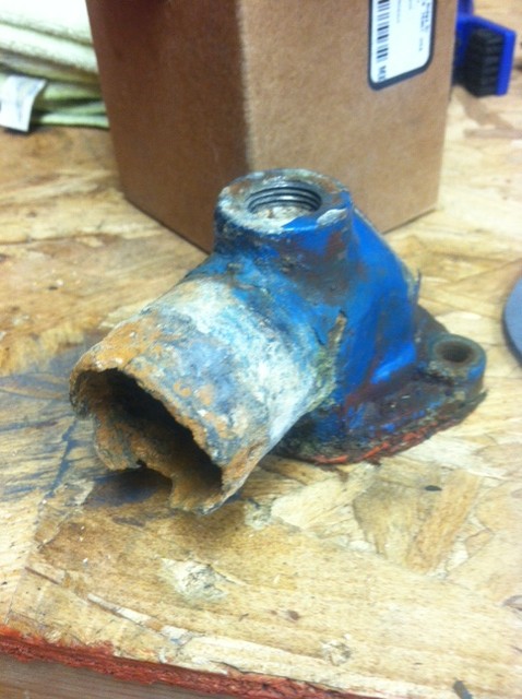 1977 Ford F-350 - This corroded part appears to be a water pump housing, showing significant rust and damage.