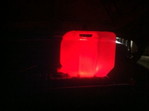 1977 Ford F-350 - A red jerrycan glows brightly in the darkness, its contents unseen.