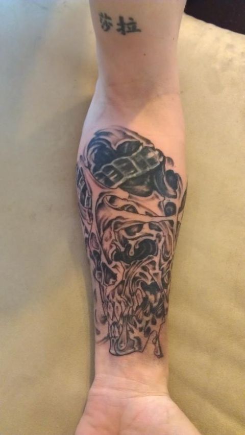 1995 Ford F-150 - A detailed tattoo of a skull covers the arm, with some text visible above the artwork.