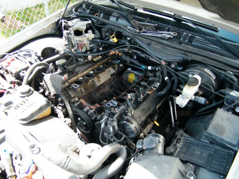 2004 Ford Crown Victoria - The engine bay of a vehicle, with the intake manifold removed, revealing the engine's internal components.