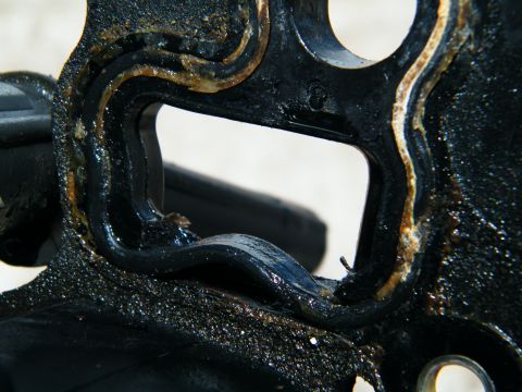 2004 Ford Crown Victoria - This engine part has a worn gasket, indicating potential leaks or the need for replacement.