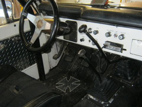 1970 Ford Bronco - Interior view of a 1970 Ford Bronco, custom floor mats and aftermarket radio.