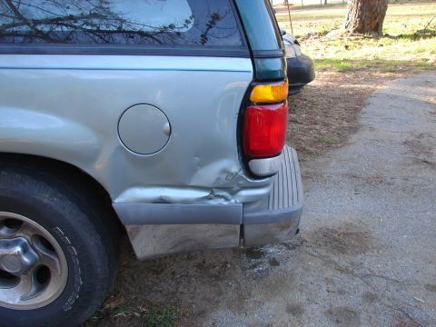 1973 Ford Ranchero - The rear of a silver SUV shows significant damage to the quarter panel and bumper.