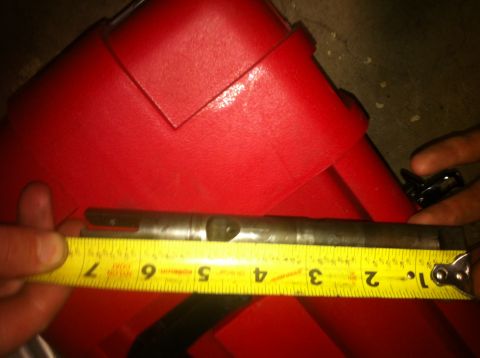 1989 Ford Bronco - A metal rod is being measured with a tape measure, showing approximately 6 inches.