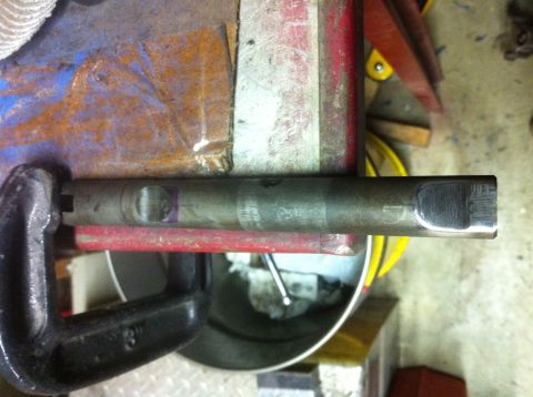 1989 Ford Bronco - Metal shaft secured in a vise, possibly for modification or repair.