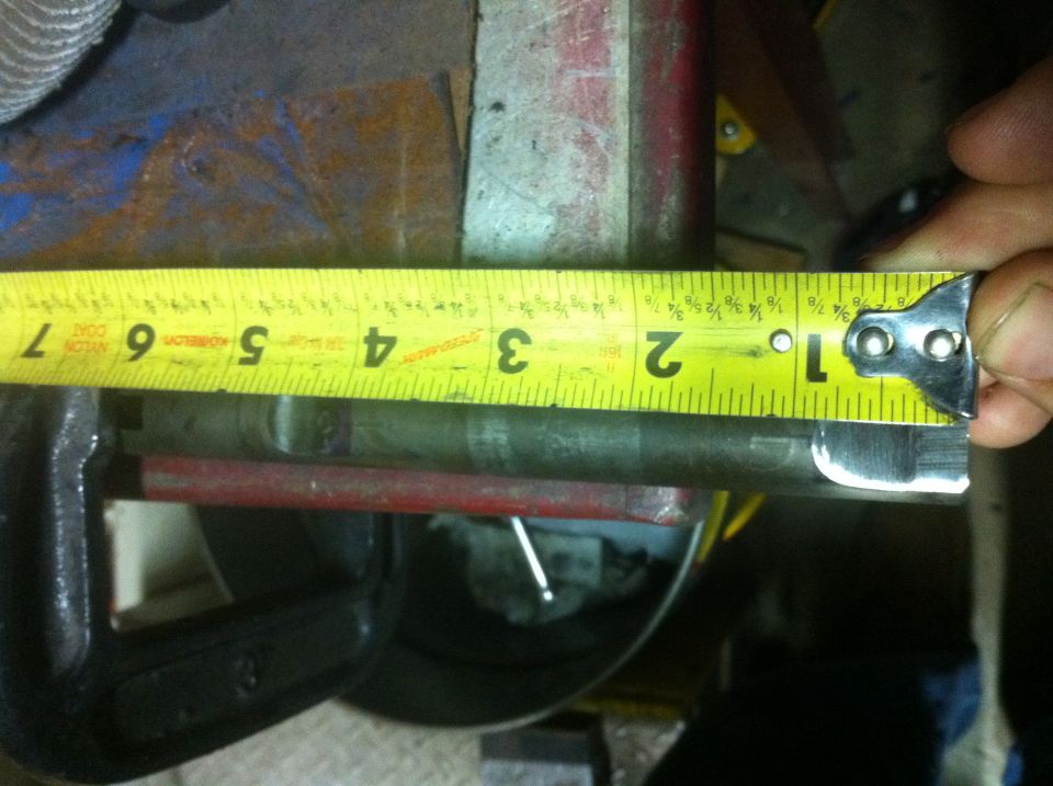 Tape measure shows metal rod is about 1.5 inches in diameter