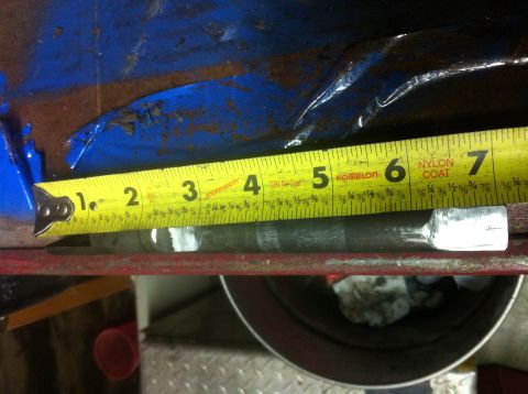 1989 Ford Bronco - A tape measure is used to measure a metal rod, indicating a length of approximately 6 inches.