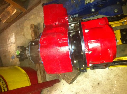 1989 Ford Bronco - Transfer case assembly, likely for a 4x4 vehicle, painted red and mounted on blocks.