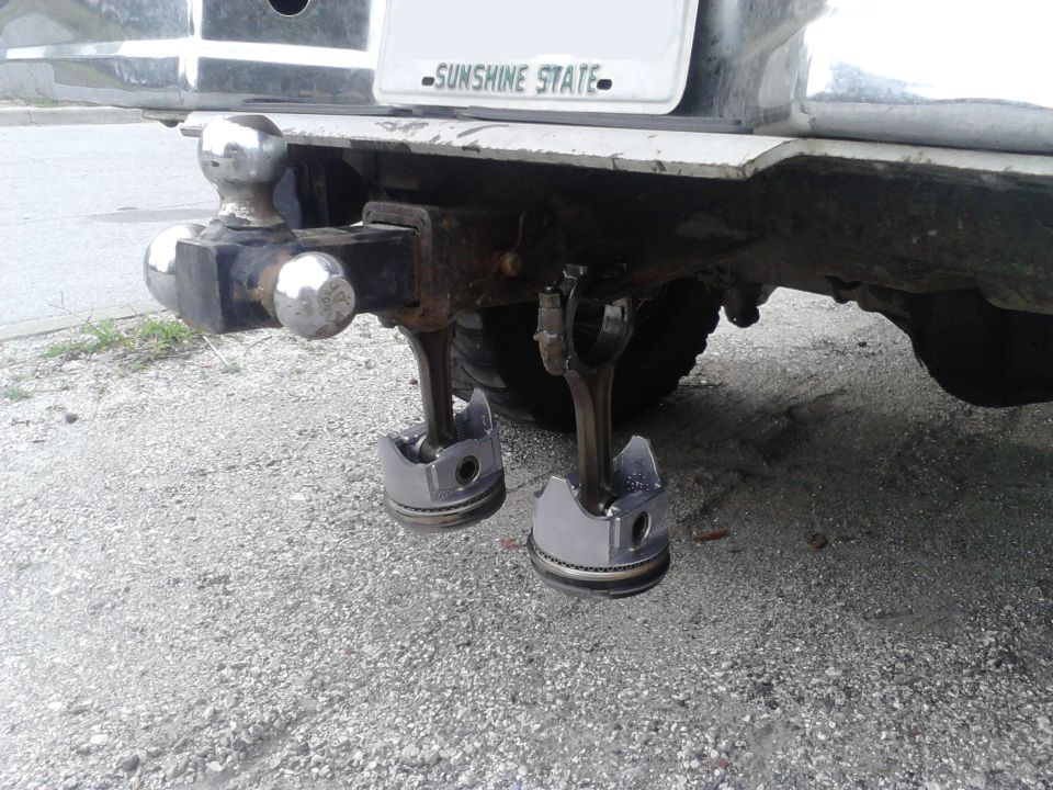 Piston exhaust tips attached to a truck's trailer hitch