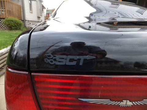 1970 Ford Ranchero - The SCT emblem is visible on the trunk of a black car, with a reflection of the photographer in the background.
