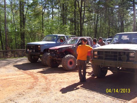 1990 Ford Bronco - Modified off-road trucks and a buggy gathered on a sunny day.