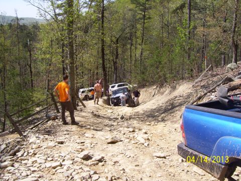 1990 Ford Bronco - Multiple SUVs on a challenging off-road trail, with a blue pickup in the foreground. Date: 04/14/2013.
