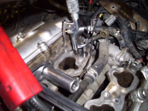1995 Ford Probe - Mechanic working on engine parts, using tools for repair or maintenance.