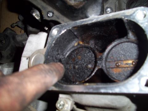 1995 Ford Probe - Close-up of a heavily carboned intake manifold, showing two throttle body openings.