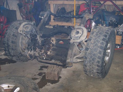 1988 Suzuki Samurai - Suzuki Samurai chassis undergoing modification, showing engine and suspension parts.
