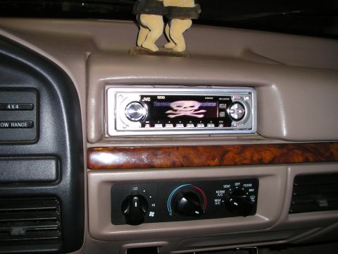 1996 Ford Bronco - Dashboard interior a JVC stereo and climate controls, with a decorative figurine on top.