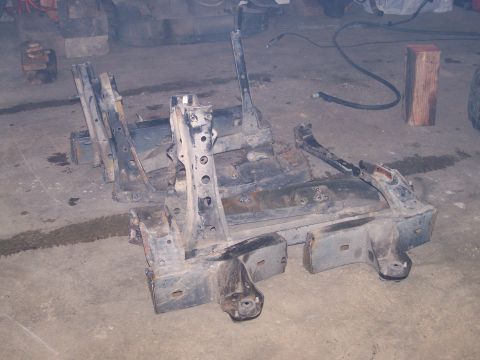 1988 Suzuki Samurai - Disassembled vehicle frame sections are shown on a concrete floor, with a "SUPERMOTORS.NET" watermark at the bottom right.