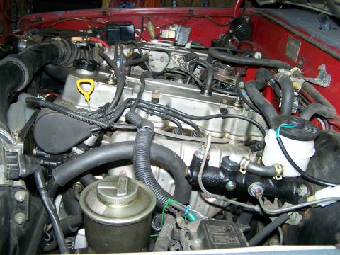 1988 Suzuki Samurai - Close-up view of a V6 engine bay, the power steering reservoir and brake master cylinder.