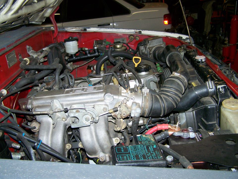 engine bay with fuel injection system and battery