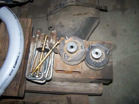 1988 Suzuki Samurai - Various suspension components, including coil springs and shock mounts, are laid out on wooden blocks.