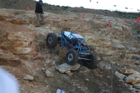 1987 Ford Bronco - This custom buggy is navigating a steep, rocky incline during an off-road event.