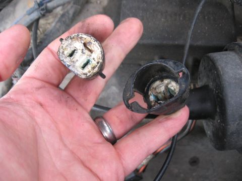 1981 Ford Bronco - Corroded electrical connector and housing components are held in a hand, likely from a vehicle's engine bay.