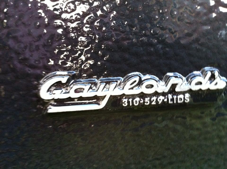 Chrome emblem reads 'Gaylords 310-529-LIDS' on a dark textured surface