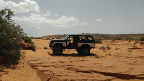 1994 Ford Bronco - This 1994 Ford Bronco is seen parked in a desert environment with sandstone formations.