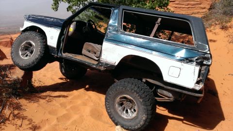 1994 Ford Bronco - This 1994 Ford Bronco is shown off-roading on a sandy, rocky surface.