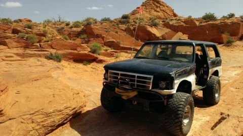 1994 Ford Bronco - This 1994 Ford Bronco is equipped for off-road adventures, with large tires and a stance against a desert backdrop.