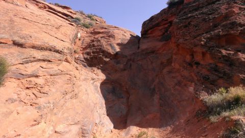 1994 Ford Bronco - A scenic view of a desert canyon with red rock formations under a clear blue sky. The Supermotors logo is visible in the lower right corner.