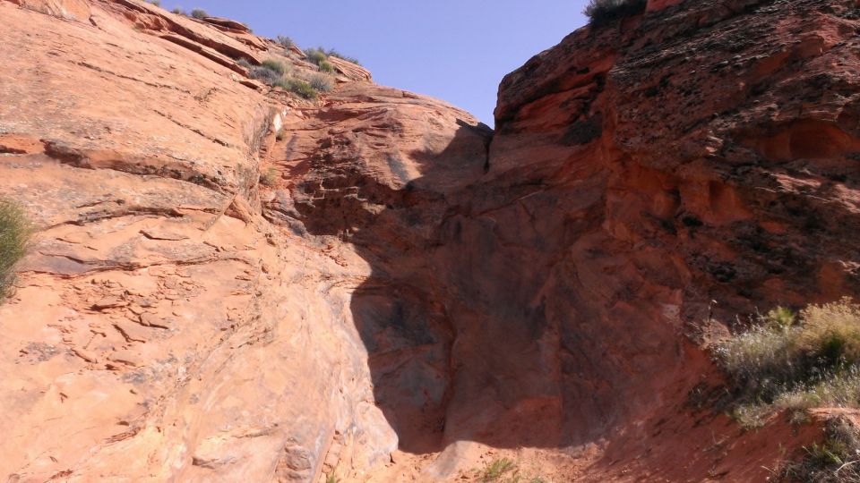 Rocky canyon landscape with blue sky and Supermotors logo