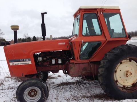 1987 Ford F-250 - An orange Allis-Chalmers AC 7000 tractor with a white cab sits in a field covered in snow.